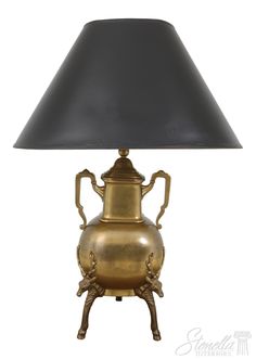 an antique brass urn lamp with black shade