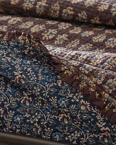 a blue and brown floral quilted bed spread