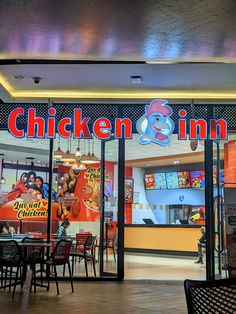 the inside of a fast food restaurant with chicken and inn sign on the front door