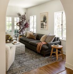 a living room filled with furniture and lots of windows