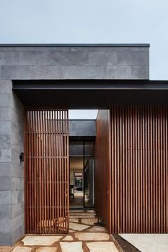 an entrance to a house with wooden slats