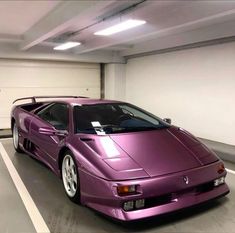 a purple sports car parked in a parking garage