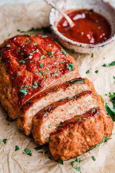 meatloaf with sauce and herbs on the side