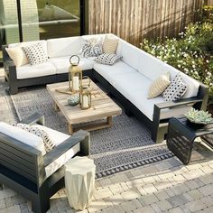 an outdoor living area with couches and tables