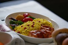 a white bowl filled with food on top of a table