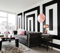 a living room with black and white striped walls