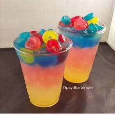 two plastic cups filled with candy and gummy bears