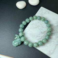 🌅Jade bead bracelet: Also called the buddha bead, symbol the spirit of Buddhism, suitable for the people who believe in Buddhism or have a heart for being kind 🌅Pixiu (貔貅) is an imaginary creature in form of a winged lion, representing auspiciousness and wealth. It is believed that Pixiu can ward off evil spirits too. 🍀JadeousJade: An Etsy StarSeller of natural Jadeite Jade jewelry for your daily mix and match 🌟Item Details: * 100% AUTHENTIC: Grade A untreated natural Jade bracelet * DETAIL HANDCRAFTED: Handcrafted in detail & finely polished * PROPERTY: Bring Protection, Safe and Calm * INNER LENGTH: 16 cm with elastic string (with wrist size length 15-16cm) * DIMENSION of GREEN JADE BEAD: 10mm each * DIMENSION of GREEN JADE PIXIU: 14mm x 6mm * WEIGHT: 37g each (approx.) 💝We hope you Crystal Bracelets Diy, Jade Bead Bracelet, Pixiu Bracelet, Buddhist Beads, Winged Lion, Real Green, Buddha Beads, Purple Jade, Jewelry Men