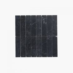 black marble tiles arranged in rows against a white background