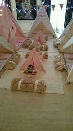 a group of tents sitting on top of a wooden floor next to a tv screen