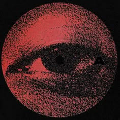 an eye is shown in the middle of a red and black circle with dots all over it