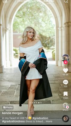 a woman in a graduation gown posing for the camera with her hand on her hip