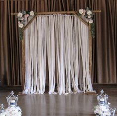 the wedding stage is decorated with white flowers and drapes