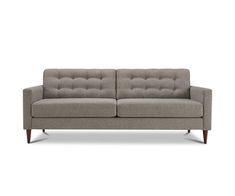 a gray couch with wooden legs and buttons on the armrests, against a white background