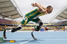 a man in green and yellow running on a blue track with the words he moy