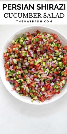 a white bowl filled with cucumber salad on top of a table