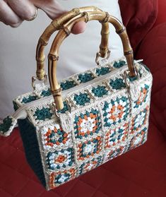 a person holding a handbag made out of crochet