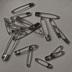 a bunch of metal clips sitting on top of a table