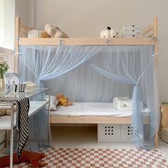 a child's bedroom with a canopy bed and checkered rugs on the floor