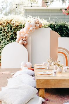 a table set for two with white and pink decorations