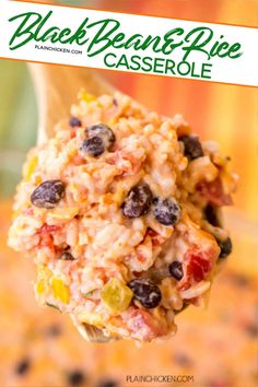 a spoon full of rice with raisins and black beans on it, in front of a sign that says black bean and pie casserole