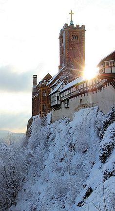 a snow covered hill with a church on top