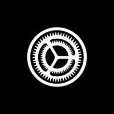 a black and white logo with gears in the shape of a circle on a dark background