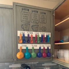 a kitchen with lots of pots and pans on the wall