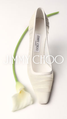 a white shoe with a flower on the side