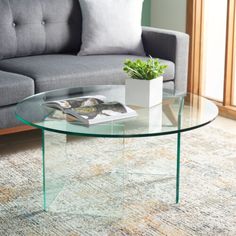 a glass coffee table with a magazine on it