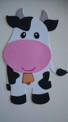 a paper cut out of a cow wearing a tie