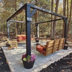 a wooden gazebo sitting in the middle of a forest