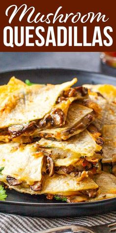 mushroom quesadillas on a black plate with cilantro and parsley