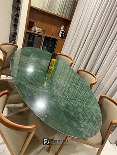 a glass table with four chairs around it