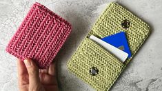 two crocheted wallets one is pink and the other is green