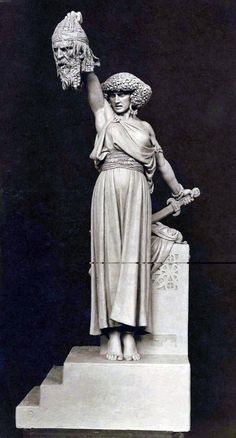 a statue of a woman holding a bird in her hand