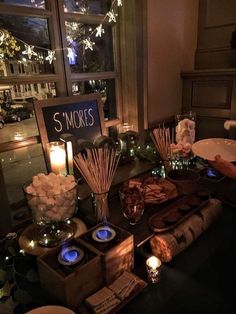 the table is set up with candles, flowers and other items for guests to enjoy