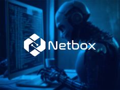 a person wearing headphones sitting in front of a computer with the netbox logo on it