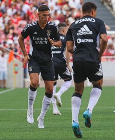 two soccer players are running after the ball