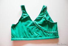 a green sports bra top on a white surface