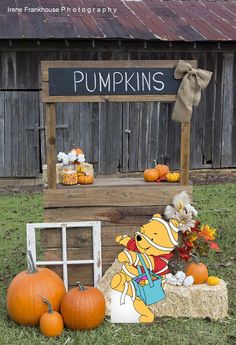 pumpkins on display in front of an old wooden crate with a sign that says pumpkins