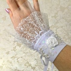 One pair detachable cuff bracelet with embroidery is made of various lace and tulle in  shades of white. It is decorated with a embroidered flowers, seed bead, payettes. The whole composition has a Victorian, elegant air and can be the piece of resistance for any outfit. You can wear them like on wedding or with dress! They are adjustable! Sizes of wrist is from 17 to 20 cm Measures: Wide: 17 cm (6.5 inches) Hight: 15 cm (6 inches) This is UNIQUE piece. Detachable Cuffs, Handcuff Bracelet, Lace Cuff Bracelet, Embroidery With Sequins, Fabric Cuff Bracelet, Embroidered Cuffs, Hand Cuff Bracelet, Embroidered Ribbon, Cuff Bracelets Handmade