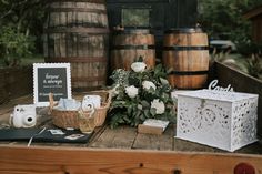 a wooden table topped with baskets filled with flowers and other items on top of it