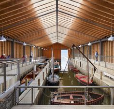 the inside of a building with several small boats