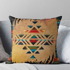 a decorative throw pillow with an abstract design on the front and back side, featuring triangles