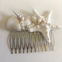 there is a hair comb with sea shells and starfishs attached to the comb