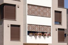 an apartment building with flower boxes on the balconies