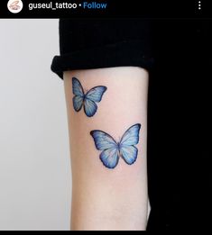 two blue butterflies tattoo on the arm