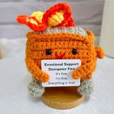 an orange crocheted stuffed animal with a sign on it that says,'i'm fine everything is fine '