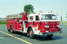 a red fire truck parked in a parking lot